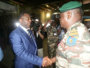 Minister of Defense, Edgard Alain Mebe Ngo (L) congratulates Col Gabriel Mvogo from Cameroon after decoratng him