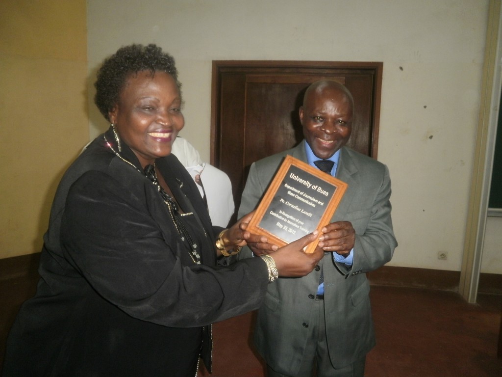 Prof. Lambi (R) receives an award from Prof. Martha Tumnde, Dean, Faculty of Social & Management Sciences, UB