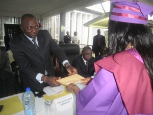 Southwest Governor, Okalia Bilai (L) offers a prize to a graduate