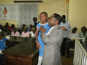 Charles Mbella Moki, Buea Mayor comforts a pupil who's a beneficiary