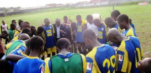 Tiko United players & coach praying after victory 