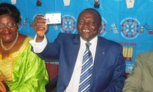 Governor Okalia Bilai happily brandishes his voters' card