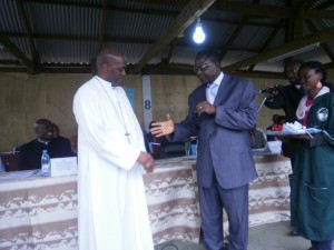 Clement Fon Ndikum hands keys of tractors to Mgr. Bushu Chancellor of UIDB.