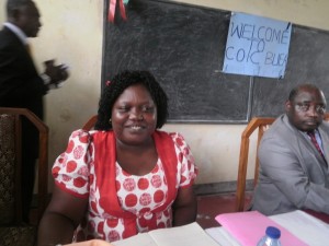 A gleeful looking Director of COIC, Clara Limunga at the signing ceremony at COIC