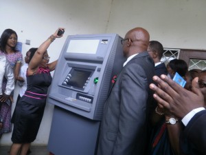 Dr Nalova Lyonga officially opens Ecobank's ATM machine, while other officials look on