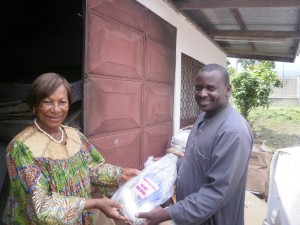 Dr. Abel Kome(R) of the Buea Regional Hospital receives a sample of the Surgical Consumables from Madam Clara Mbua, Cameroon Director of Makuna International