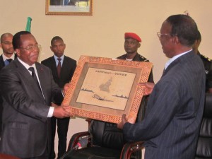 Robert Nkili (Left) hands over a portrait of souvenir to Hon Sallah Abdoulie 