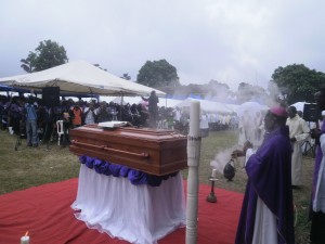 Archbishop Cornelius Esua, ordained priest by Mgr. Awa, does the commendation before the burial of of the fallen prelate