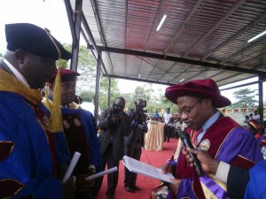 Prof. Maurice Tchuente(R), UB Pro-Chancellor, confers Doctoral Degrees to Clement Nkwemoh and Kingsley Ngange