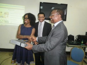 Dr. Susan Engema(1st from left) in handshake & handing gift to Dr Victor Mbome Njie, Southwest Delegate of Health