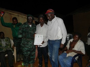 Conservator of KNP(in mufti) pose for a souvenir pic with other villagers of Esukutan with a copy of the agreement