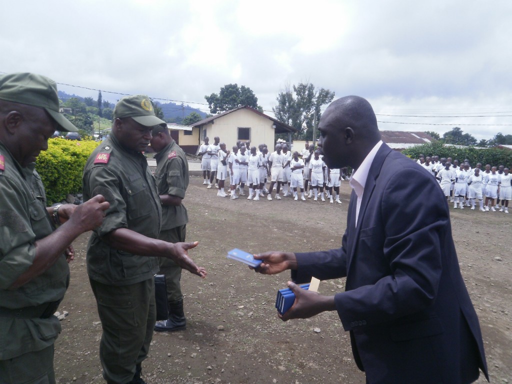 Makomra (R) distributes Bibles to stduents of ENAP