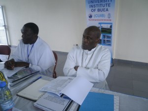 Mgr. Bushu (R) and Fr. Nkeze follow deliberations at the CUIB Board meeting
